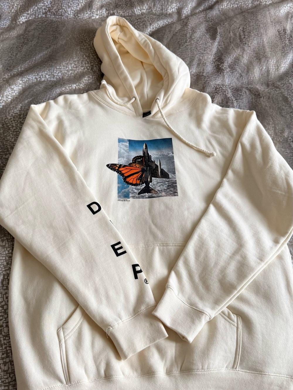 10.Deep Cream Hoodie with Orange Butterfly Chest Graphic